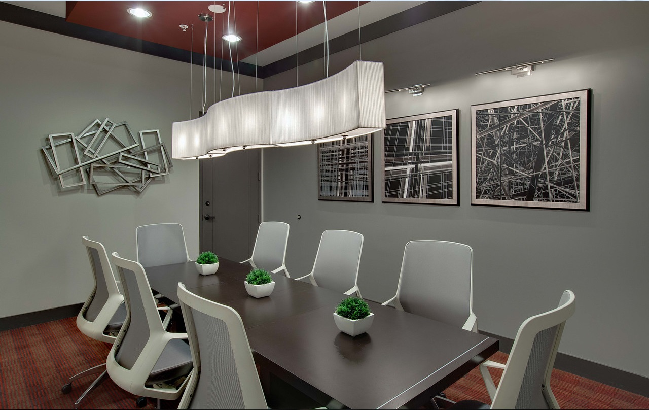 business center meeting room with modern lighting and seating