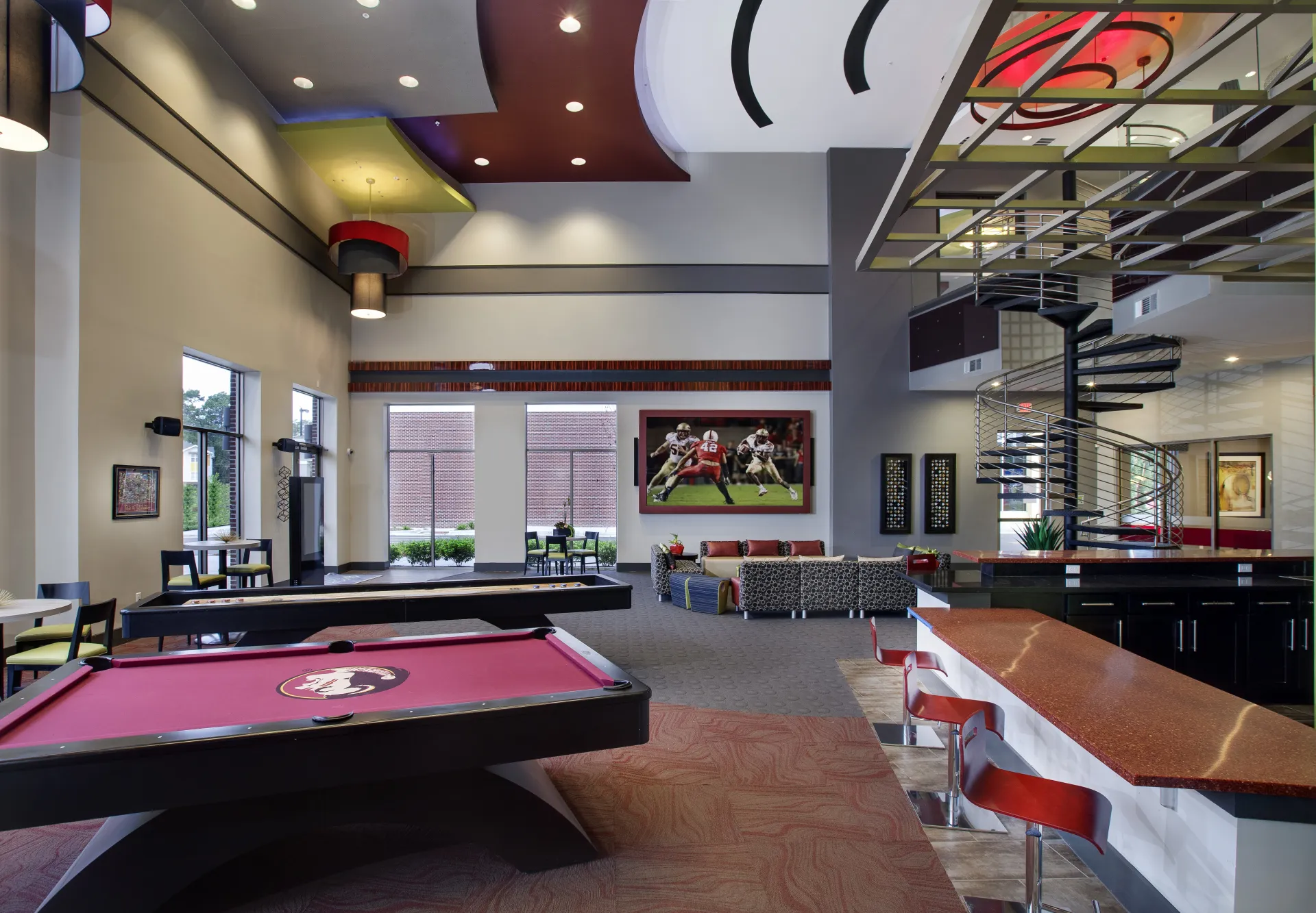 community area with pool table, shuffleboard and tables and couches